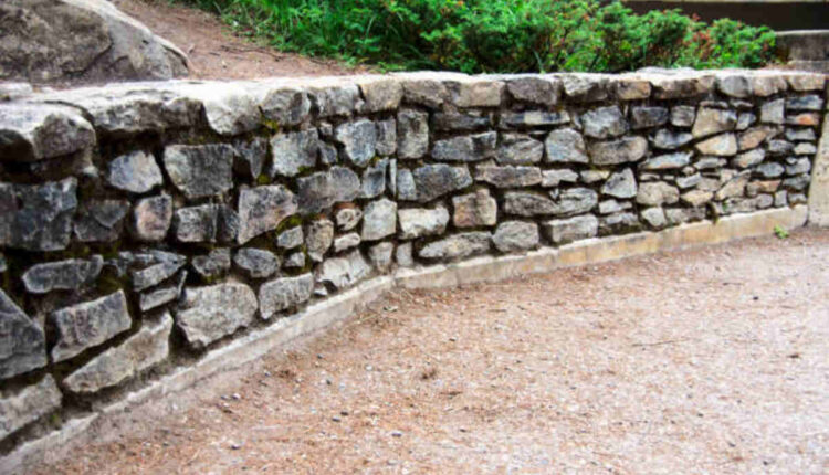 neighbors retaining wall falling on my property